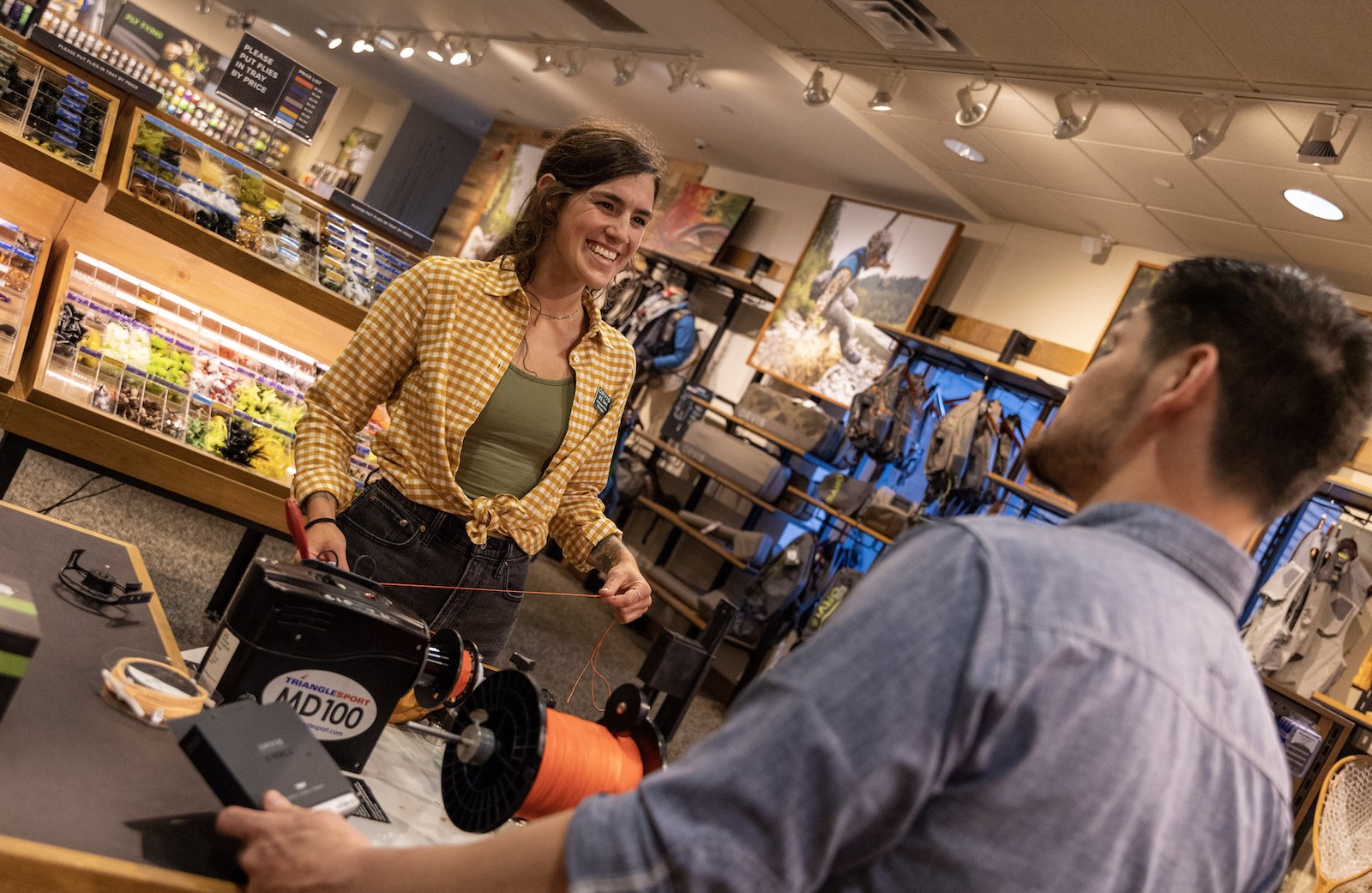 Orvis Employee smiling while talking to another person